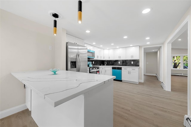 28 Snowberry Ln, Islandia, NY 11749 - kitchen with appliances with stainless steel finishes, white cabinetry, light stone countertops, a baseboard radiator, and decorative backsplash