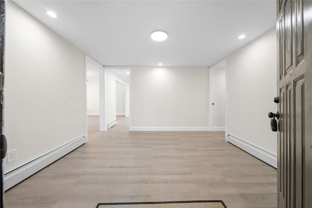 28 Snowberry Ln, Islandia, NY 11749 - spare room featuring a baseboard heating unit, a baseboard radiator, light wood-style floors, and recessed lighting