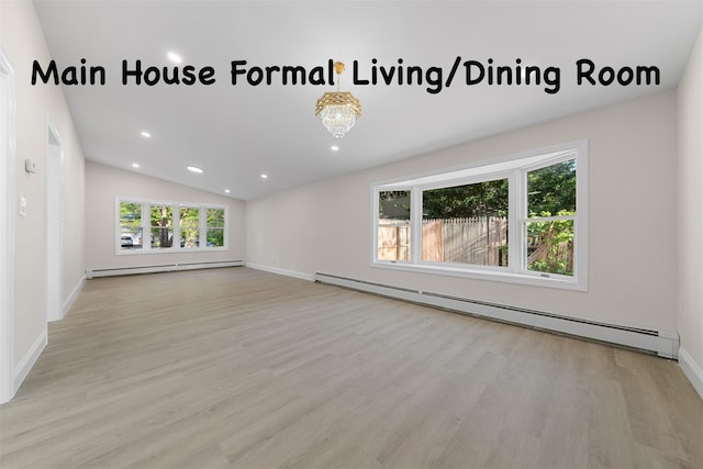 28 Snowberry Ln, Islandia, NY 11749 - empty room with baseboard heating, wood finished floors, plenty of natural light, vaulted ceiling, and recessed lighting
