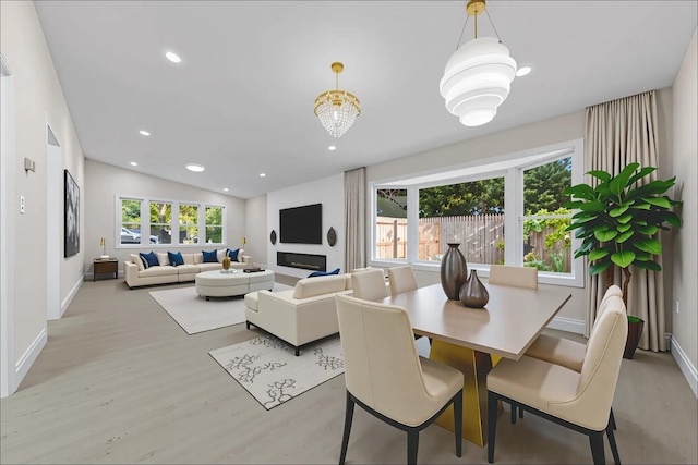 28 Snowberry Ln, Islandia, NY 11749 - dining area with plenty of natural light, wood finished floors, vaulted ceiling, and recessed lighting