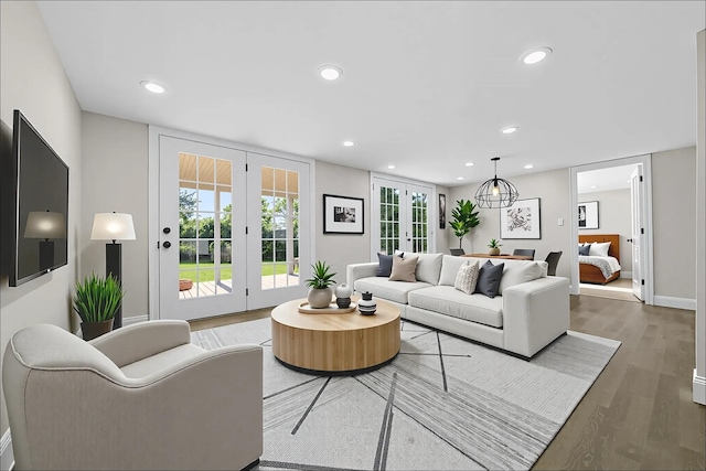 28 Snowberry Ln, Islandia, NY 11749 - living room featuring wood finished floors, french doors, and recessed lighting