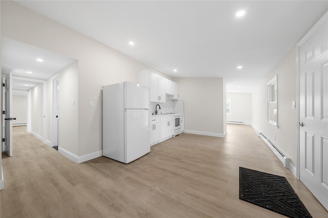 28 Snowberry Ln, Islandia, NY 11749 - kitchen featuring freestanding refrigerator, a baseboard radiator, light wood-type flooring, baseboard heating, and white cabinets
