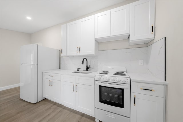 28 Snowberry Ln, Islandia, NY 11749 - kitchen with white appliances, white cabinetry, light wood finished floors, tasteful backsplash, and light stone counters
