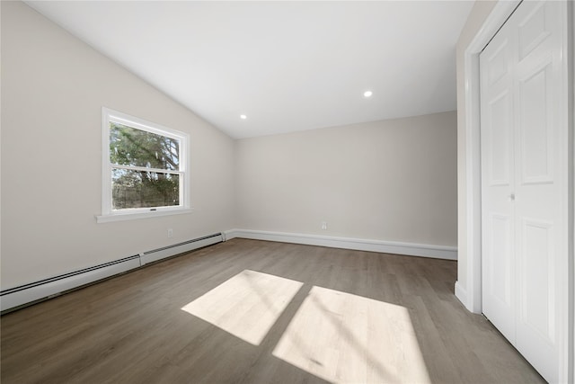 28 Snowberry Ln, Islandia, NY 11749 - unfurnished bedroom with wood finished floors, baseboard heating, recessed lighting, and a closet