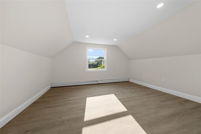 28 Snowberry Ln, Islandia, NY 11749 - additional living space featuring a baseboard heating unit, wood finished floors, lofted ceiling, and recessed lighting