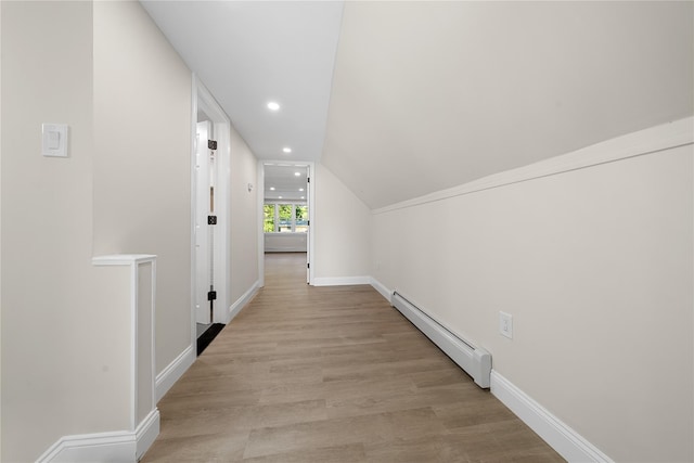 28 Snowberry Ln, Islandia, NY 11749 - hall featuring a baseboard radiator, light wood-type flooring, recessed lighting, and lofted ceiling