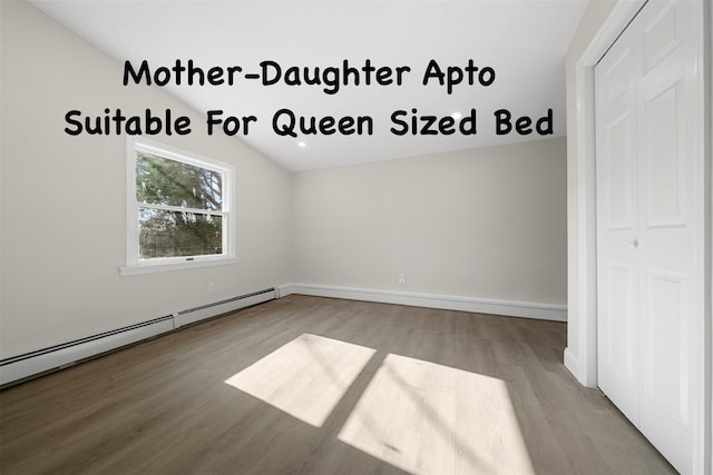 28 Snowberry Ln, Islandia, NY 11749 - empty room with wood finished floors and a baseboard radiator