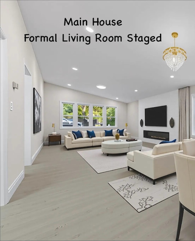 28 Snowberry Ln, Islandia, NY 11749 - living room featuring wood finished floors, recessed lighting, and a chandelier