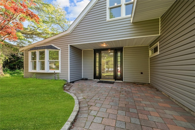 28 Snowberry Ln, Islandia, NY 11749 - doorway to property with a patio and a yard