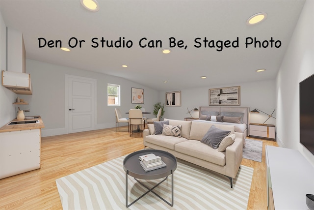 28 Snowberry Ln, Islandia, NY 11749 - living area with light wood finished floors and recessed lighting