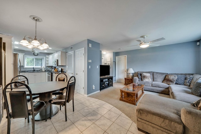 74 Gauguin Ct Unit 74, Middle Island, NY 11953 - living area with light colored carpet, a ceiling fan, light tile patterned flooring, a chandelier, and baseboards