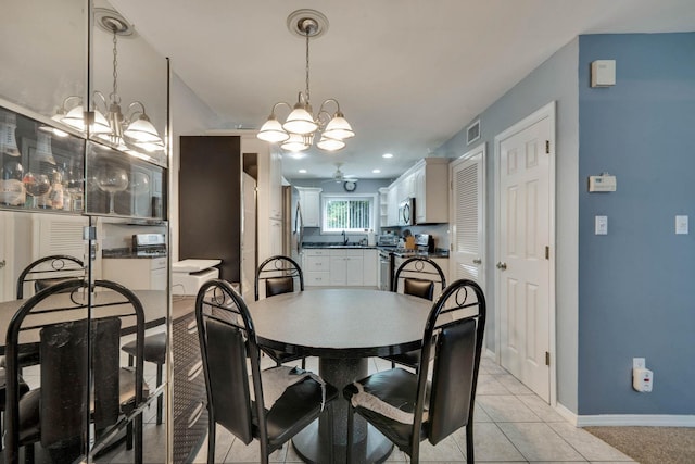 74 Gauguin Ct Unit 74, Middle Island, NY 11953 - dining space with a chandelier, light tile patterned floors, and baseboards