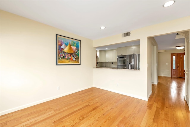 2917 Frankel Blvd, Merrick, NY 11566 - unfurnished living room featuring light wood-style floors, recessed lighting, and baseboards