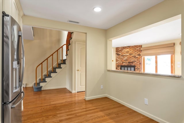 2917 Frankel Blvd, Merrick, NY 11566 - foyer entrance featuring light wood finished floors, baseboards, a fireplace, stairway, and recessed lighting