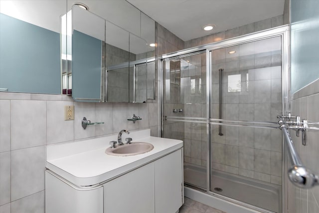 2917 Frankel Blvd, Merrick, NY 11566 - full bathroom featuring vanity, a stall shower, tile walls, and recessed lighting