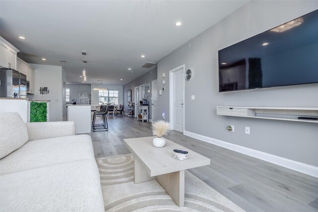 12 Grace Hall Ln, Yaphank, NY 11980 - living area featuring light wood-style flooring, recessed lighting, and baseboards