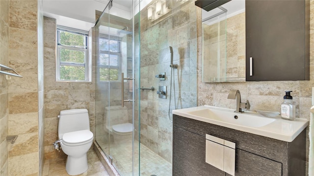 8 Barstow Rd Unit 2G, Great Neck, NY 11021 - bathroom featuring tile walls, toilet, vanity, a shower stall, and crown molding