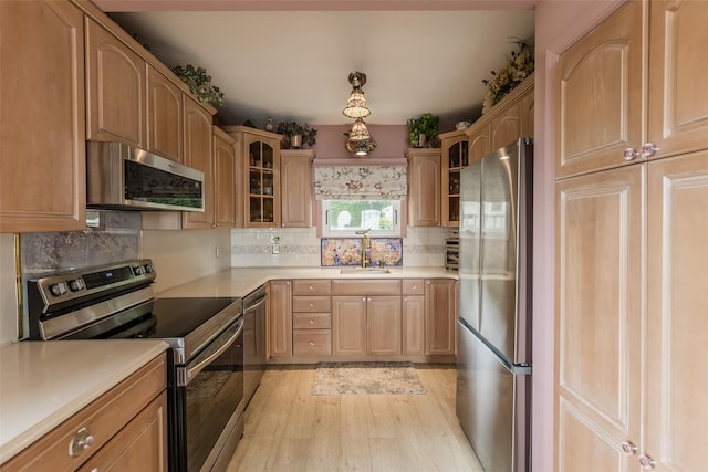 26 Point Breeze Dr, Rocky Point, NY 11778 - kitchen featuring appliances with stainless steel finishes, a sink, glass insert cabinets, light wood-style floors, and light countertops