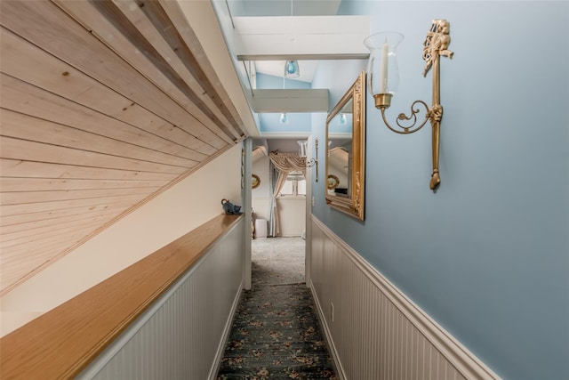 26 Point Breeze Dr, Rocky Point, NY 11778 - corridor featuring vaulted ceiling, a skylight, and a wainscoted wall