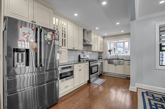 14627 Reeves Ave, Flushing, NY 11367 - kitchen featuring stainless steel appliances, wall chimney exhaust hood, a sink, dark countertops, and crown molding