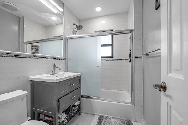 14627 Reeves Ave, Flushing, NY 11367 - full bath featuring vanity, shower / bath combination with glass door, toilet, tile walls, and recessed lighting