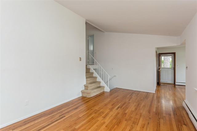 233 Violet St, Massapequa Park, NY 11762 - empty room featuring a baseboard radiator, light wood-type flooring, stairs, and baseboards