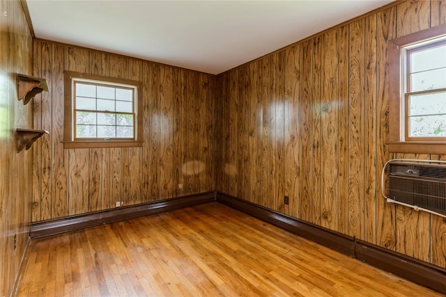 233 Violet St, Massapequa Park, NY 11762 - empty room with healthy amount of natural light, hardwood / wood-style floors, and wooden walls