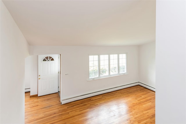 233 Violet St, Massapequa Park, NY 11762 - empty room with a baseboard heating unit and light wood-style flooring