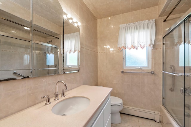 1649 Falmouth Ave, New Hyde Park, NY 11040 - bathroom featuring a baseboard radiator, vanity, tile patterned floors, tile walls, and toilet