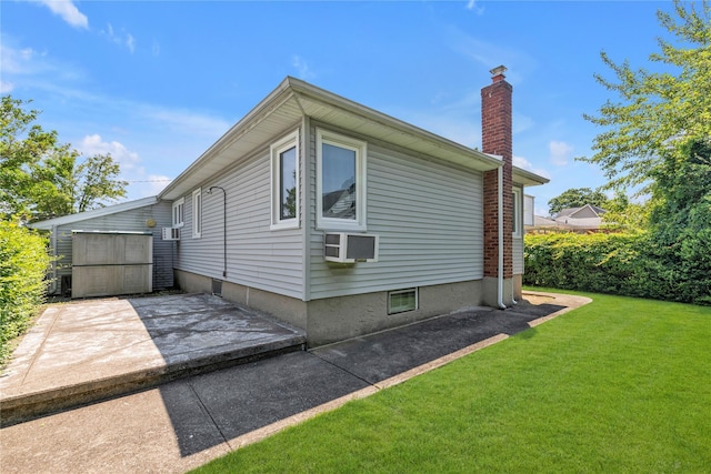 1649 Falmouth Ave, New Hyde Park, NY 11040 - view of side of home with a chimney, a yard, and a patio area