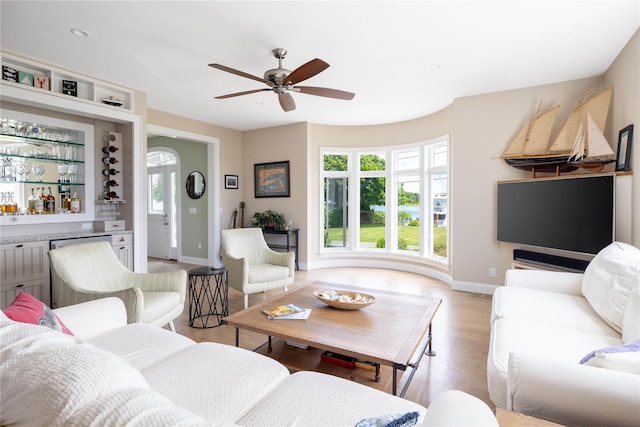 2335 Minnehaha Blvd, Southold, NY 11971 - living room with baseboards, ceiling fan, light wood finished floors, and a dry bar