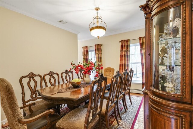68 Cauthers Ln, Woodridge, NY 12789 - dining area with ornamental molding, wood finished floors, and a baseboard radiator