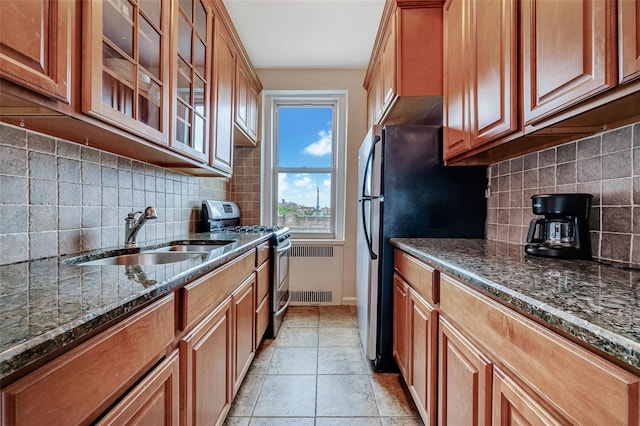 41-08 43rd St Unit 5J, Sunnyside, NY 11104 - kitchen with stainless steel gas range oven, a sink, dark stone counters, decorative backsplash, and glass insert cabinets