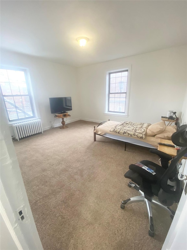 35-21 81st St Unit 5C, Jackson Heights, NY 11372 - bedroom with radiator heating unit, carpet flooring, and baseboards