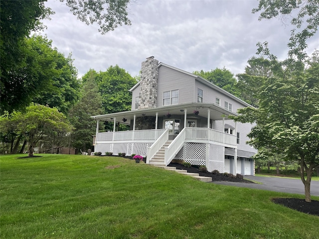 23 Saddle Rock Dr, Poughkeepsie, NY 12603 - view of front of house featuring a front yard, a garage, a chimney, and a porch