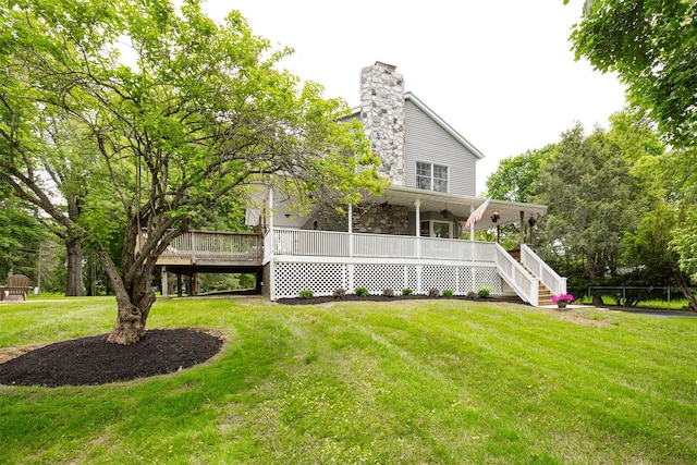 23 Saddle Rock Dr, Poughkeepsie, NY 12603 - back of house featuring a yard, stairway, a chimney, covered porch, and stone siding