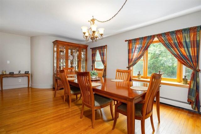 23 Saddle Rock Dr, Poughkeepsie, NY 12603 - dining space with a chandelier, light wood-style flooring, and a baseboard radiator