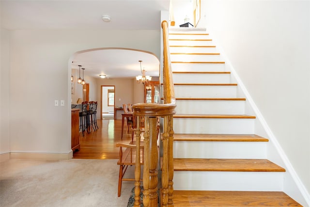 23 Saddle Rock Dr, Poughkeepsie, NY 12603 - stairway featuring arched walkways, baseboards, and carpet floors