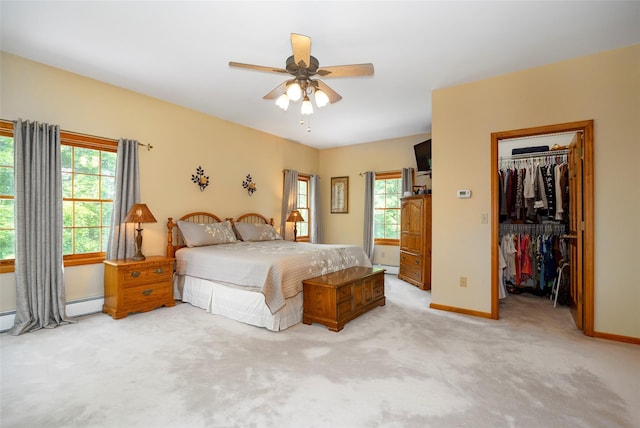 23 Saddle Rock Dr, Poughkeepsie, NY 12603 - bedroom with light carpet, multiple windows, a walk in closet, and baseboards