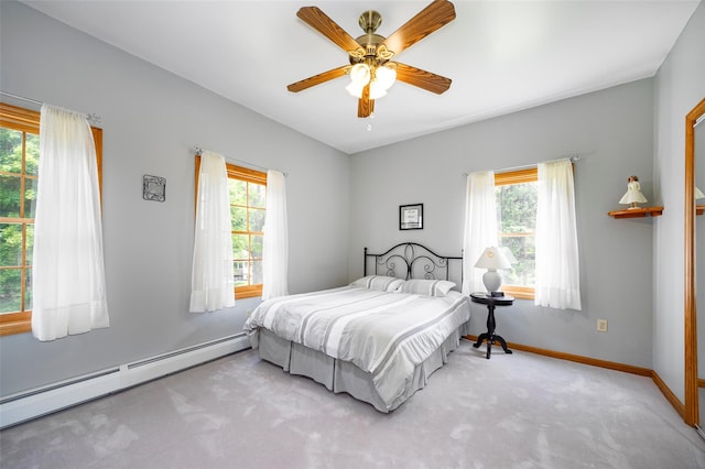23 Saddle Rock Dr, Poughkeepsie, NY 12603 - carpeted bedroom with a baseboard heating unit, multiple windows, baseboards, and a ceiling fan