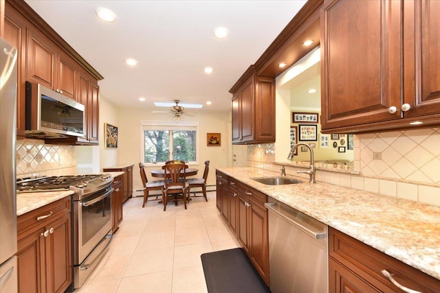 2783 Rita Ct, Bellmore, NY 11710 - kitchen with stainless steel appliances, a sink, decorative backsplash, a ceiling fan, and light tile patterned flooring
