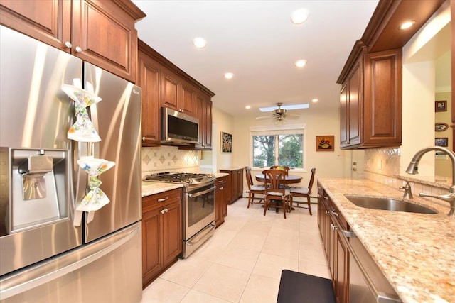 2783 Rita Ct, Bellmore, NY 11710 - kitchen with appliances with stainless steel finishes, a sink, a ceiling fan, tasteful backsplash, and light tile patterned floors