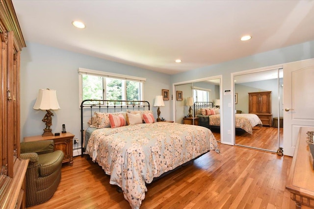 2783 Rita Ct, Bellmore, NY 11710 - bedroom with multiple closets, multiple windows, a baseboard heating unit, light wood-style floors, and recessed lighting