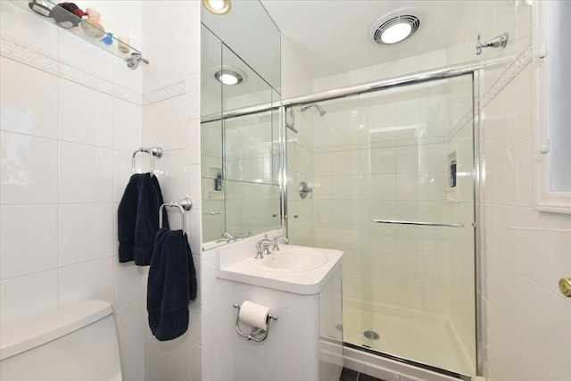 2783 Rita Ct, Bellmore, NY 11710 - bathroom with toilet, a shower stall, vanity, and tile walls