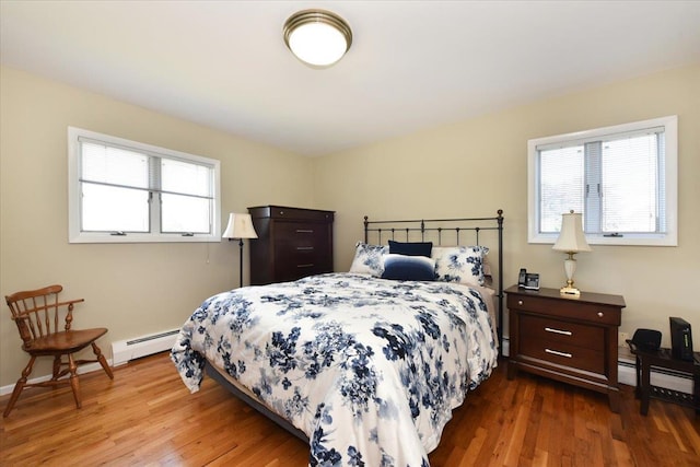 2783 Rita Ct, Bellmore, NY 11710 - bedroom featuring baseboard heating and wood finished floors