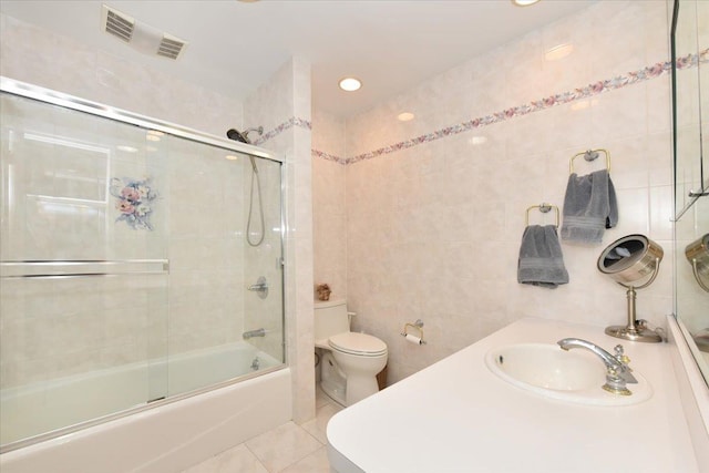 2783 Rita Ct, Bellmore, NY 11710 - bathroom featuring tile walls, tile patterned flooring, toilet, bath / shower combo with glass door, and recessed lighting