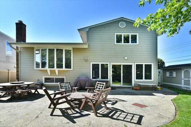 2783 Rita Ct, Bellmore, NY 11710 - back of house featuring a patio area and a chimney