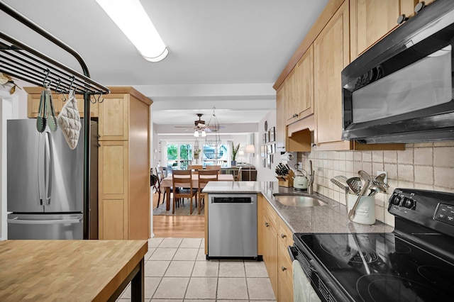 37 Scenic Cir, Croton-On-Hudson, NY 10520 - kitchen with black appliances, light brown cabinets, light tile patterned floors, tasteful backsplash, and a peninsula