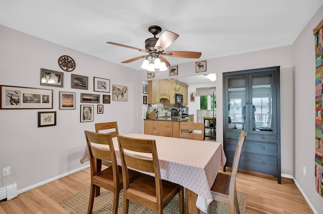 37 Scenic Cir, Croton-On-Hudson, NY 10520 - dining area featuring light wood-style floors, a ceiling fan, and a baseboard heating unit
