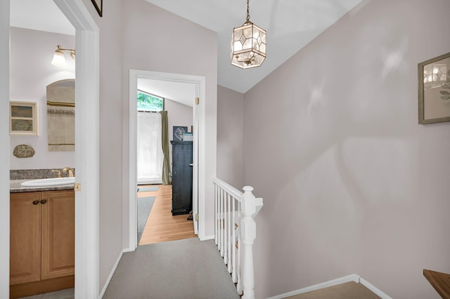 37 Scenic Cir, Croton-On-Hudson, NY 10520 - corridor featuring an upstairs landing, vaulted ceiling, light colored carpet, and a chandelier